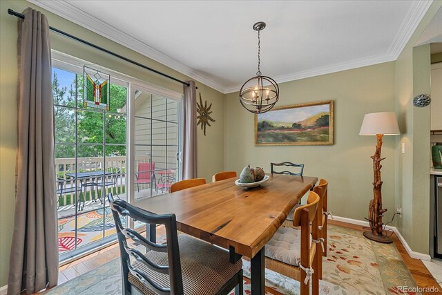 10389 W Fair Ave Unit E, Littleton, CO 80127 - dining space with a chandelier, light wood-type flooring, baseboards, and ornamental molding