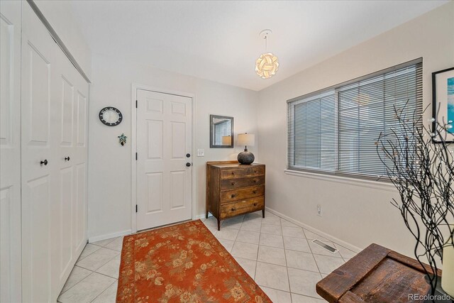 10389 W Fair Ave Unit E, Littleton, CO 80127 - entrance foyer featuring light tile patterned floors and baseboards