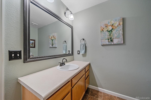 10389 W Fair Ave Unit E, Littleton, CO 80127 - bathroom featuring vanity, baseboards, and tile patterned floors