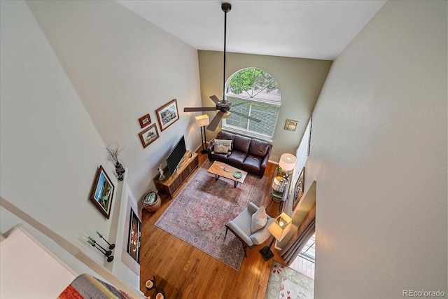 10389 W Fair Ave Unit E, Littleton, CO 80127 - living area featuring wood finished floors, a high ceiling, and ceiling fan