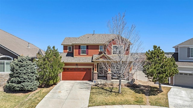view of front of home featuring roof with shingles, brick siding, driveway, and an attached garage