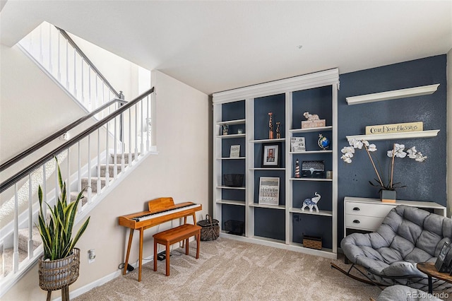 living area featuring stairway, baseboards, and carpet floors