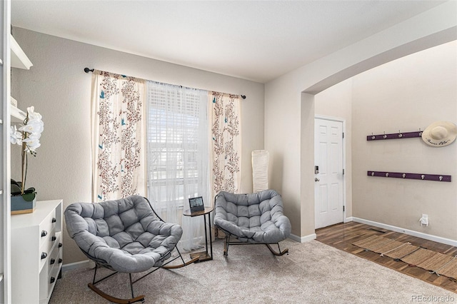 living area featuring baseboards and wood finished floors