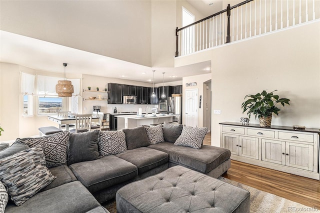 living room with recessed lighting, plenty of natural light, and wood finished floors