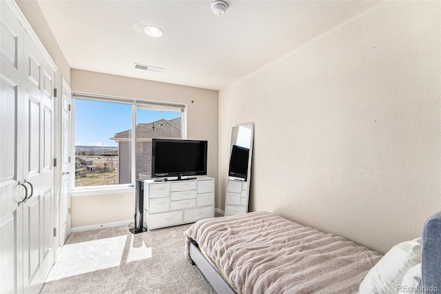 bedroom featuring light carpet, visible vents, and baseboards