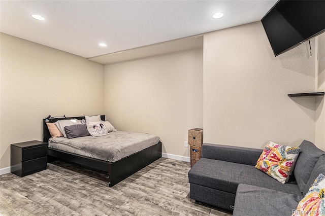 bedroom with baseboards, recessed lighting, and wood finished floors