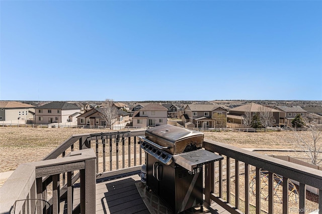 wooden terrace featuring a grill and a residential view