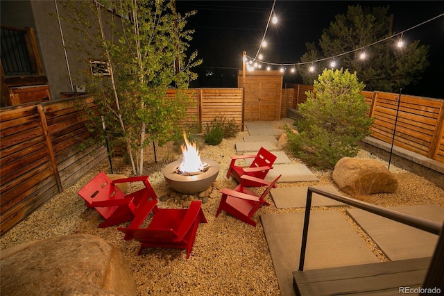 467 E Arkansas St, Buena Vista, CO 81211 - patio at night featuring an outdoor fire pit and a fenced backyard