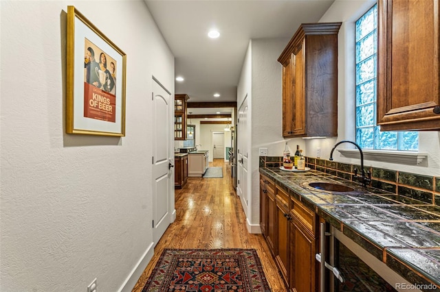 hall featuring sink and light wood-type flooring