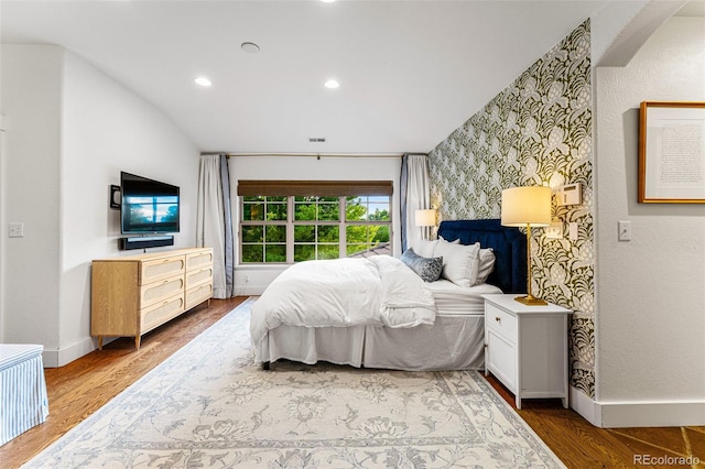 bedroom featuring wood-type flooring and lofted ceiling