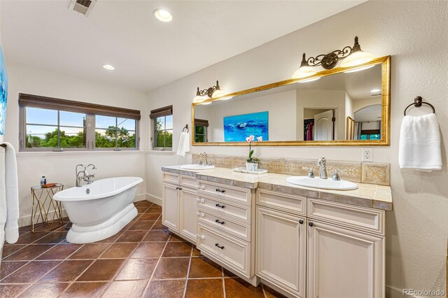 bathroom featuring a tub to relax in and vanity