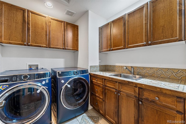 laundry room with cabinets, sink, light tile patterned floors, and independent washer and dryer