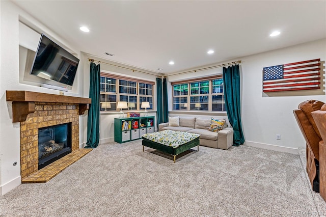 living room featuring carpet floors and a brick fireplace