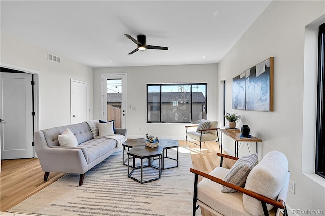 living room featuring recessed lighting, a ceiling fan, baseboards, visible vents, and light wood-style floors