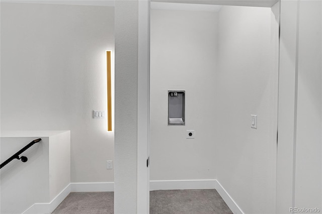 clothes washing area featuring laundry area, electric dryer hookup, and baseboards