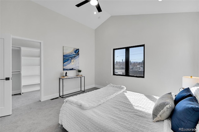 carpeted bedroom with a walk in closet, visible vents, a ceiling fan, high vaulted ceiling, and baseboards