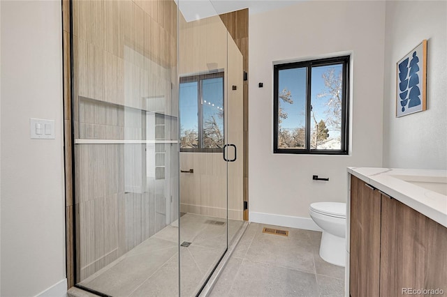 full bath with visible vents, toilet, a stall shower, vanity, and baseboards