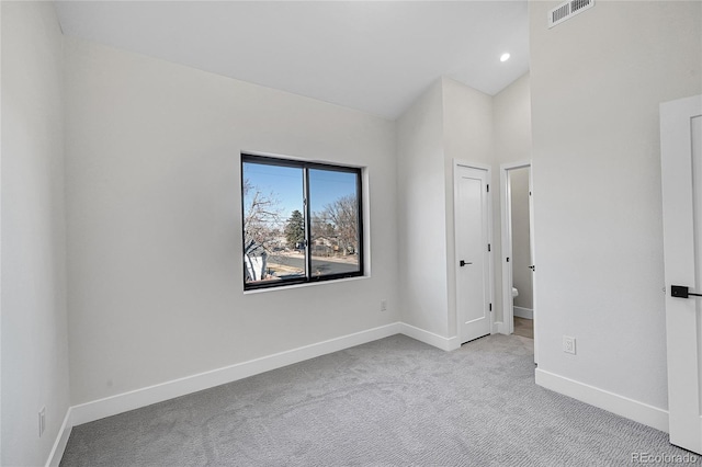 spare room with carpet floors, visible vents, baseboards, and recessed lighting