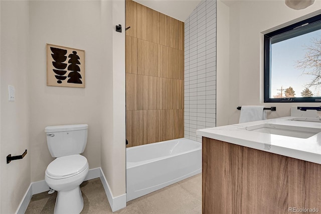 bathroom featuring baseboards, toilet, shower / tub combination, tile patterned flooring, and a sink