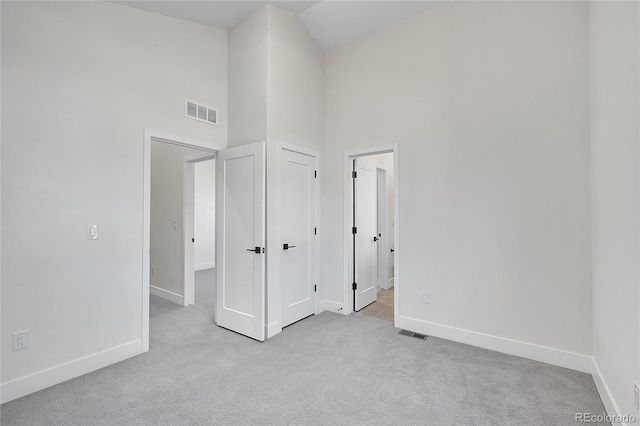 unfurnished bedroom with visible vents, baseboards, and carpet flooring