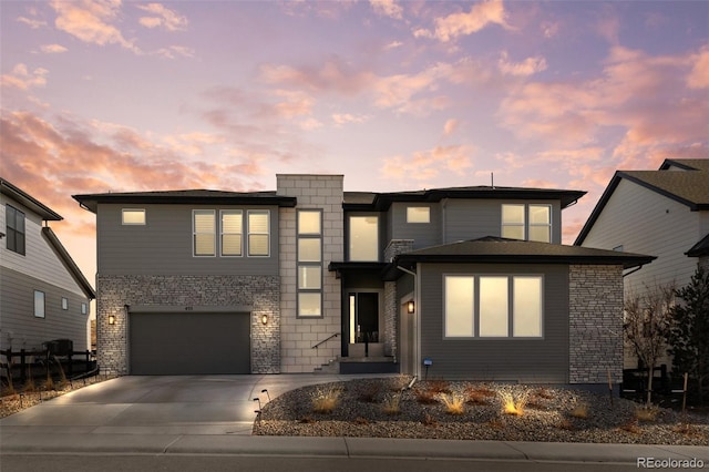 view of front facade featuring driveway, a garage, and brick siding