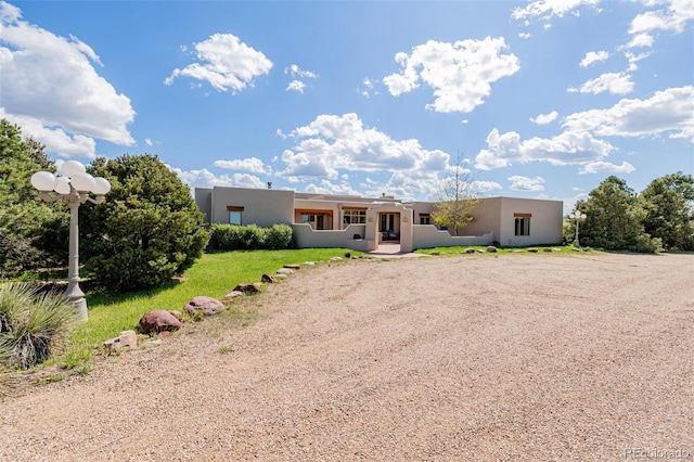 pueblo-style home with stucco siding