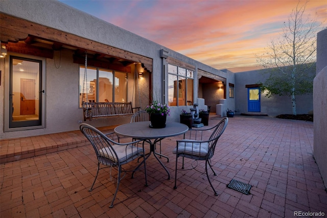view of patio terrace at dusk