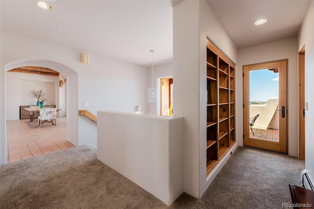 corridor featuring carpet, an upstairs landing, arched walkways, recessed lighting, and a baseboard heating unit