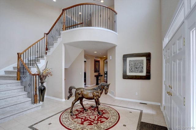 15857 E Aberdeen Ave, Centennial, CO 80016 - entryway with inlaid floor details, arched walkways, a high ceiling, tile patterned flooring, and stairway