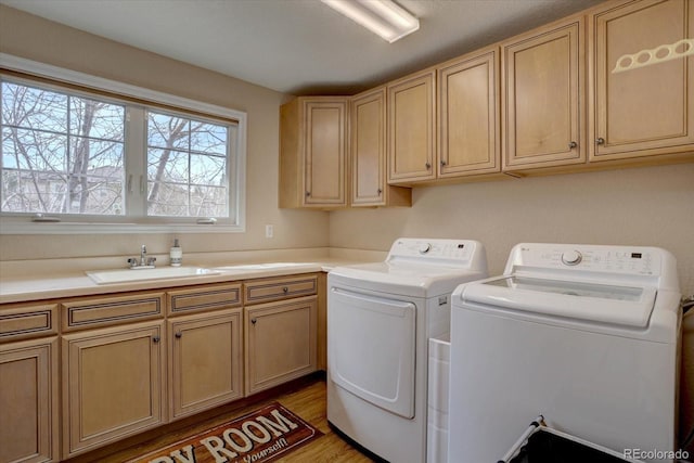 15857 E Aberdeen Ave, Centennial, CO 80016 - laundry area featuring independent washer and dryer, cabinet space, and light wood-type flooring