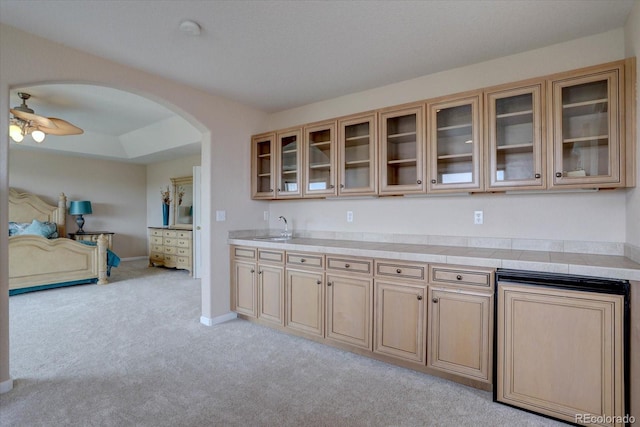 15857 E Aberdeen Ave, Centennial, CO 80016 - kitchen featuring arched walkways, a sink, light colored carpet, a ceiling fan, and light countertops
