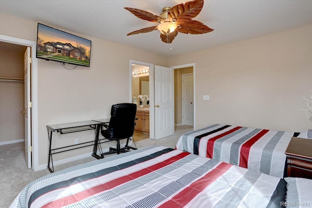 15857 E Aberdeen Ave, Centennial, CO 80016 - bedroom with light colored carpet, baseboards, ceiling fan, connected bathroom, and a spacious closet
