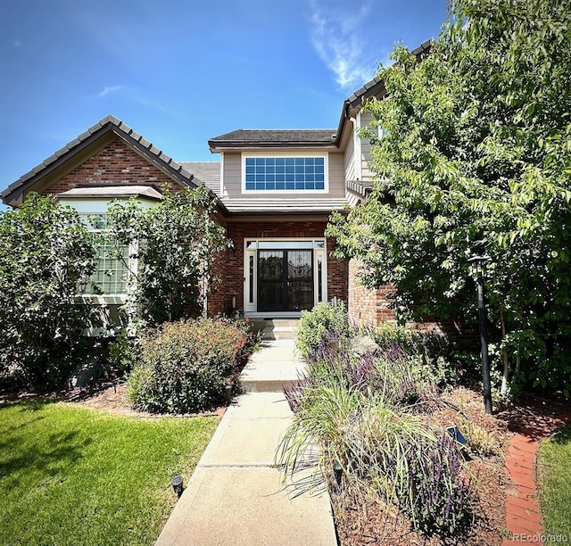 15857 E Aberdeen Ave, Centennial, CO 80016 - view of front of home with brick siding and a front lawn