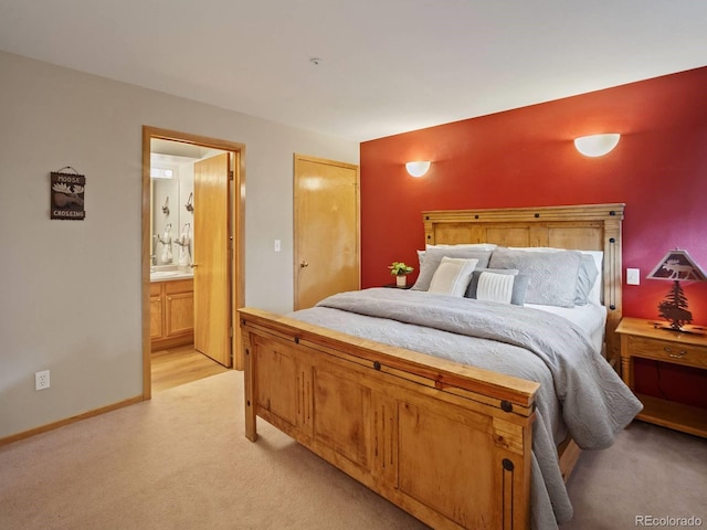 10000 Ryan Gulch Rd Unit 114, Silverthorne, CO 80498 - bedroom with light carpet, ensuite bath, and baseboards