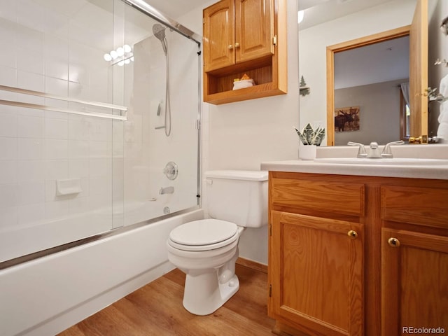 10000 Ryan Gulch Rd Unit 114, Silverthorne, CO 80498 - bathroom with toilet, wood finished floors, combined bath / shower with glass door, and vanity