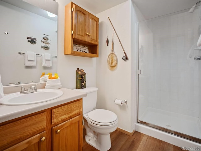 10000 Ryan Gulch Rd Unit 114, Silverthorne, CO 80498 - bathroom with a stall shower, wood finished floors, toilet, and vanity