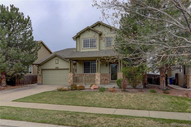 view of front of property featuring a garage, a front lawn, fence, covered porch, and driveway