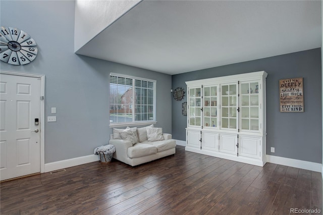 entrance foyer with baseboards, visible vents, and wood finished floors