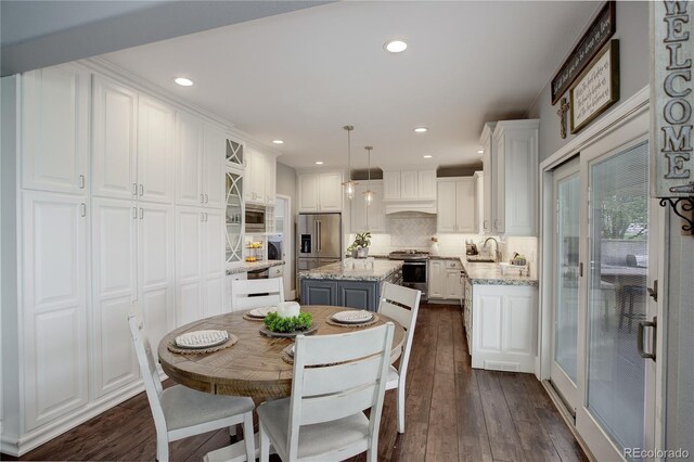 dining area featuring recessed lighting and dark wood-type flooring