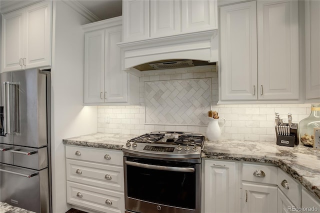 kitchen with white cabinets, light stone counters, stainless steel appliances, decorative backsplash, and ornamental molding