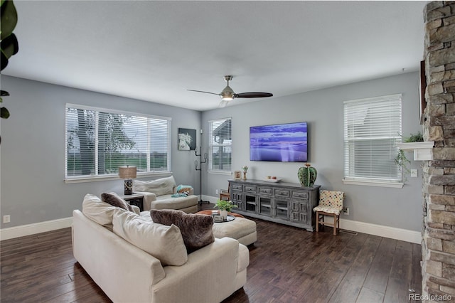 living area featuring baseboards, a ceiling fan, and hardwood / wood-style floors
