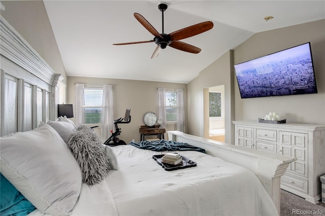 carpeted bedroom featuring a ceiling fan and vaulted ceiling