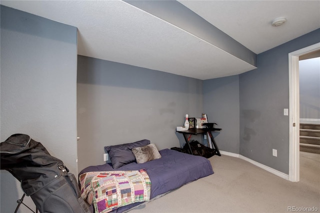 carpeted bedroom featuring baseboards