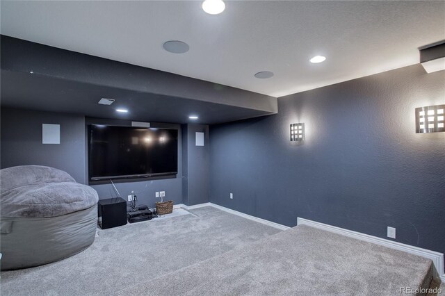 carpeted home theater room featuring baseboards, a textured wall, and recessed lighting