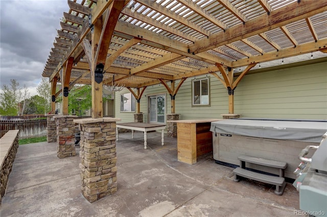 view of patio / terrace featuring a hot tub and a fenced backyard