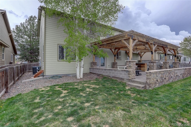 back of property featuring a lawn, a patio, cooling unit, and a fenced backyard
