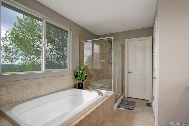 full bathroom with tile patterned flooring, a stall shower, and a garden tub