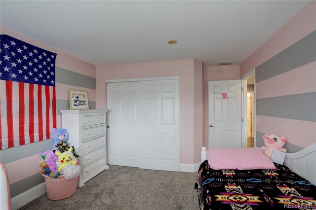 bedroom with a closet, carpet flooring, baseboards, and visible vents