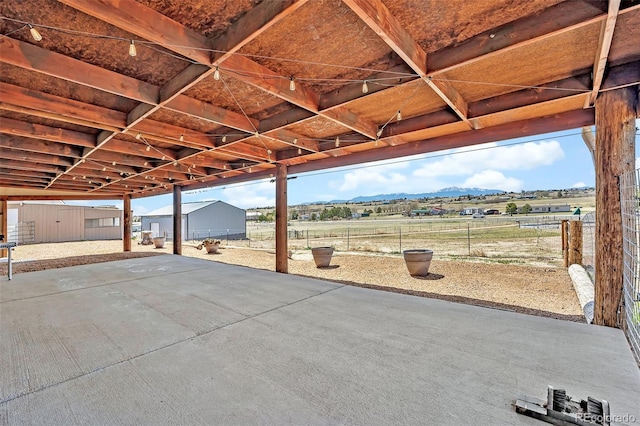 5856 John Ross Ct, Peyton, CO 80831 - view of patio / terrace with an outbuilding and a mountain view