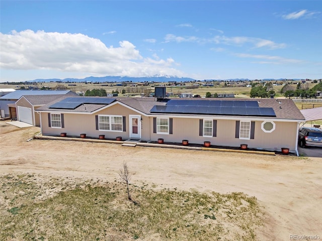 5856 John Ross Ct, Peyton, CO 80831 - single story home featuring roof mounted solar panels, driveway, and a mountain view